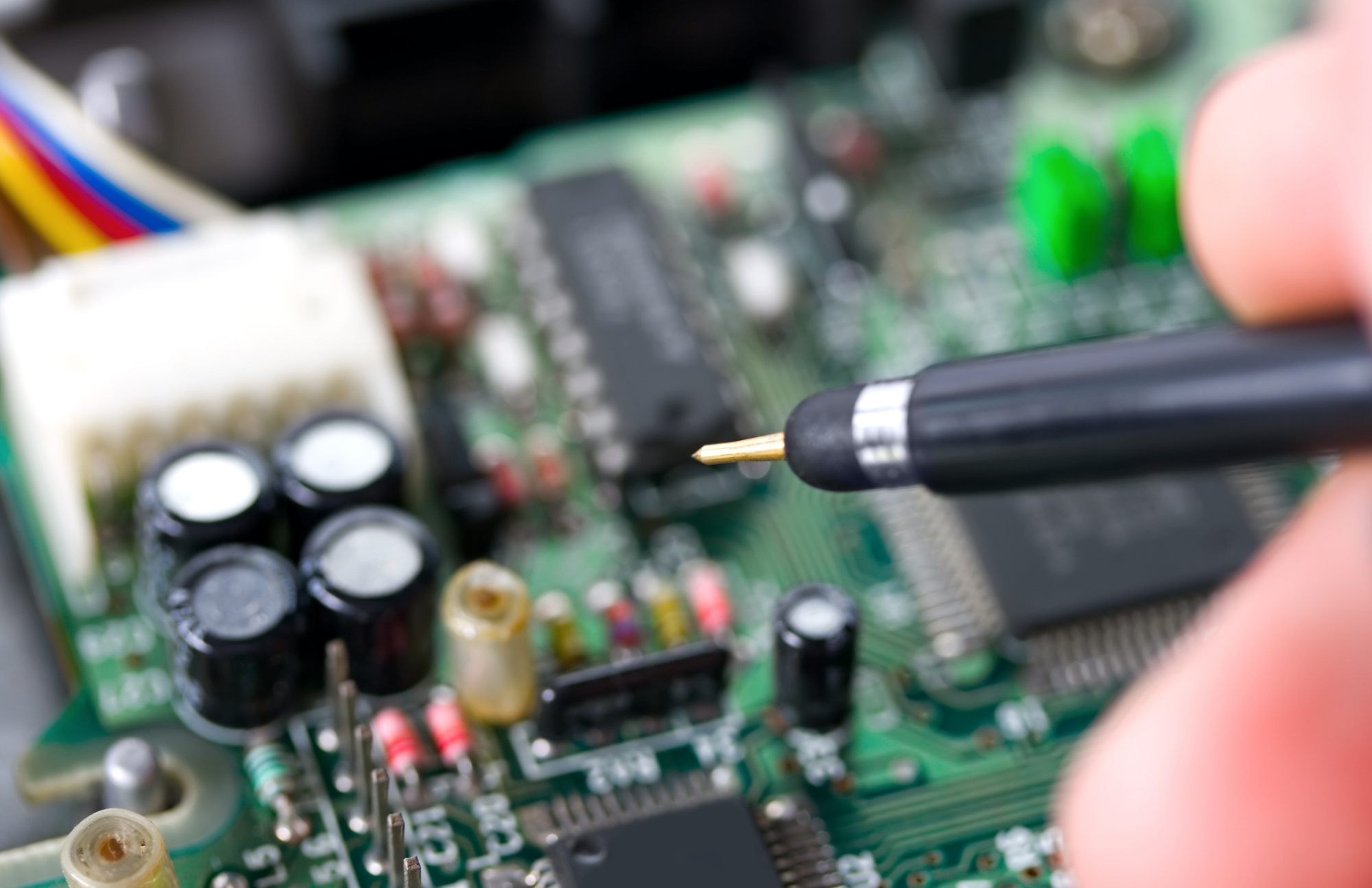 Worker soldering electronics board